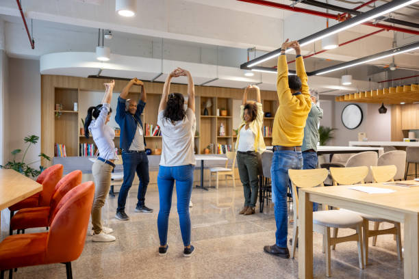 Office worker stretching at a modern desk workspace